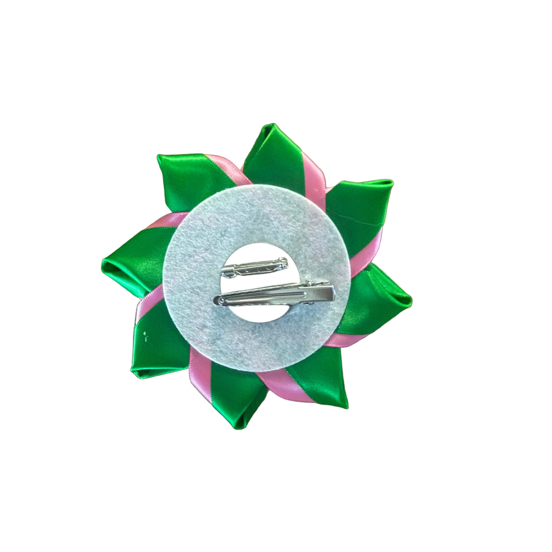 Green and pink hair bow with clear center on a brown background