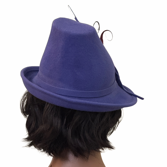 Purple hat worn by a person on a white background