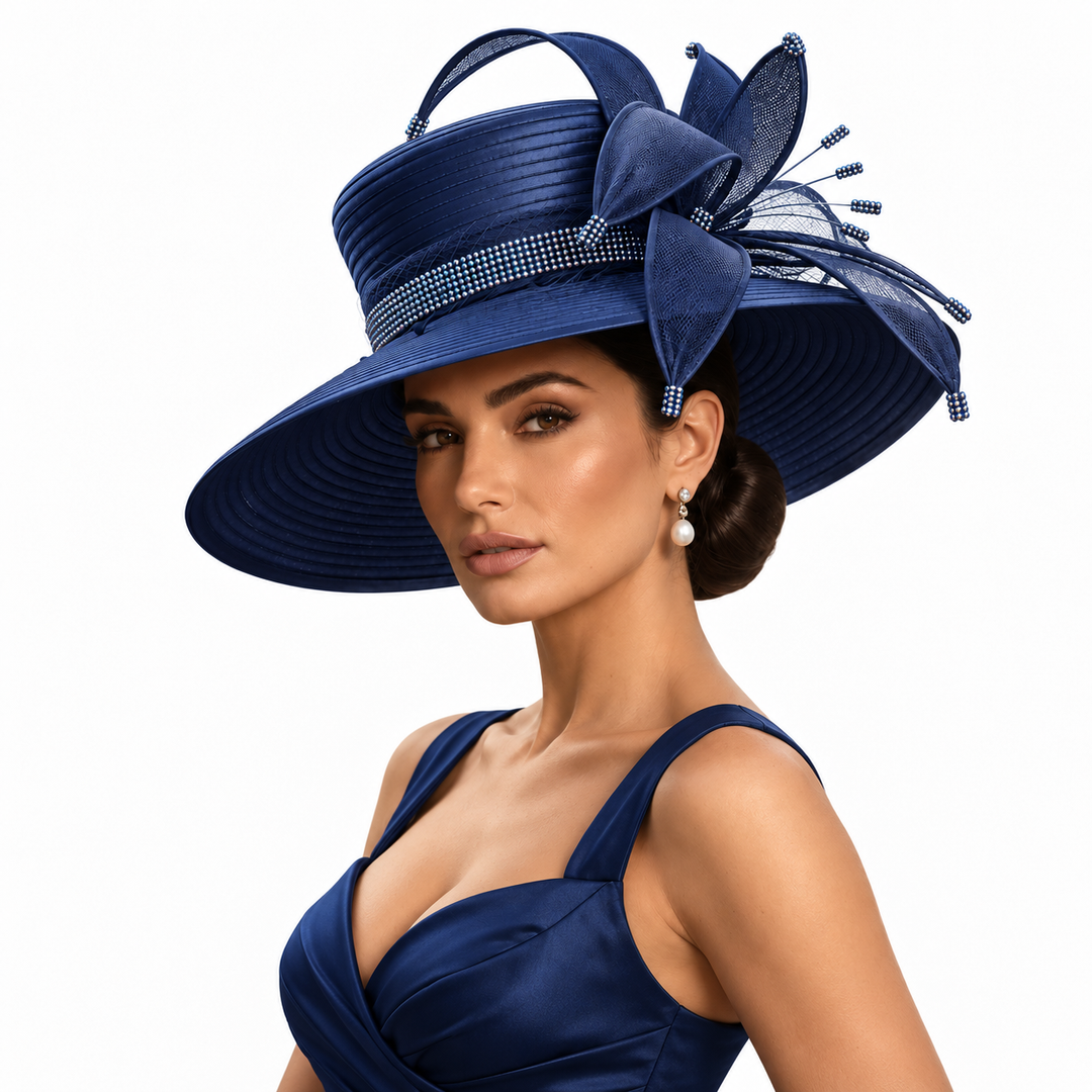 A woman wearing a navy blue wide-brimmed formal hat with a large bow, mesh side detail, and jeweled band, paired with a matching navy dress against a plain white background.