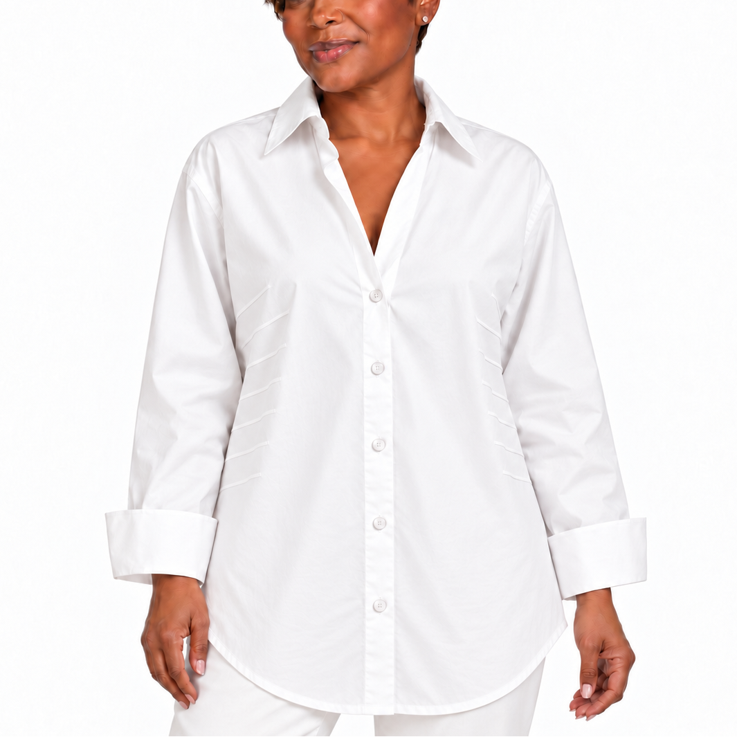 A woman modeling a white long-sleeve button-up shirt with a pointed collar, front buttons, and cuffed sleeves, photographed against a plain white studio background.