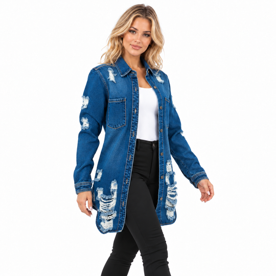 A woman modeling a distressed blue denim shirt-jacket over a white top and black pants, photographed against a plain white studio background.