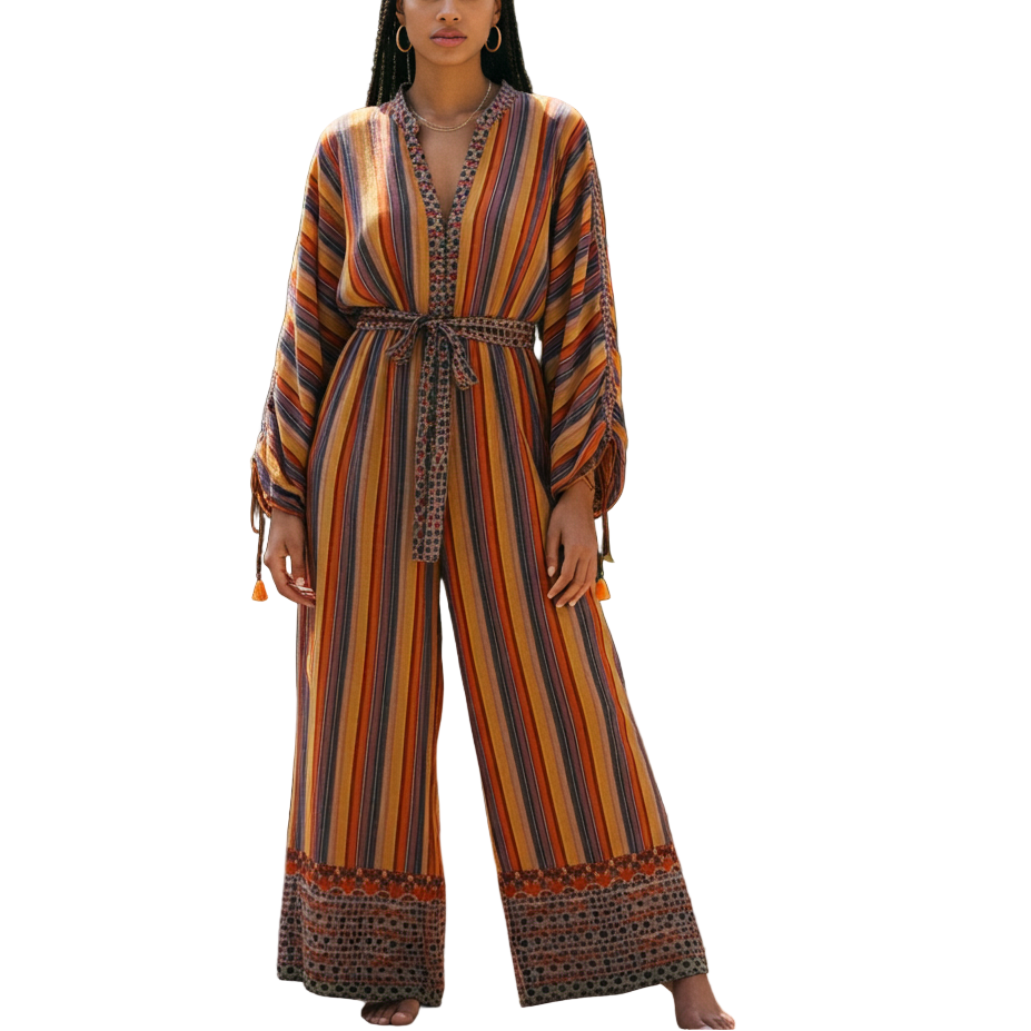 Woman in a colorful striped jumpsuit standing in a garden setting