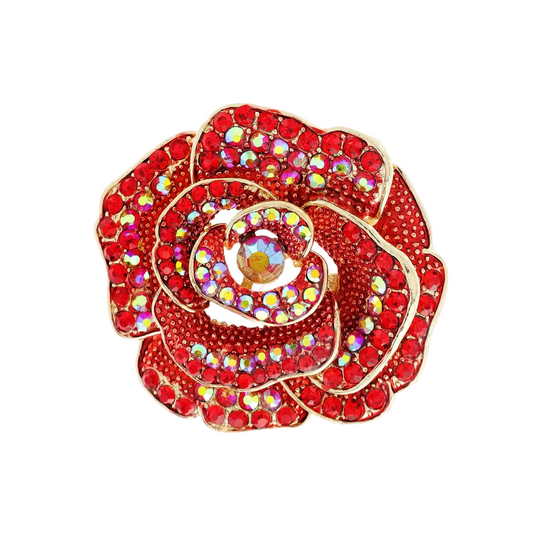 A red rose-shaped brooch pin with gold-tone metal outlines and iridescent rhinestones, shown on a plain white background with a small inset of the pin&