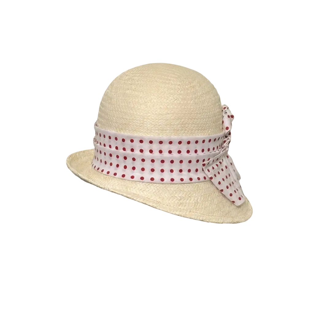 Beige straw hat with a polka dot band on a beige background