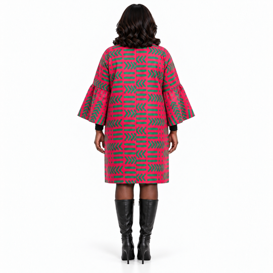 A woman viewed from the back wearing a pink and gray geometric patterned coat with flared sleeves, paired with black knee-high boots, against a plain white background.