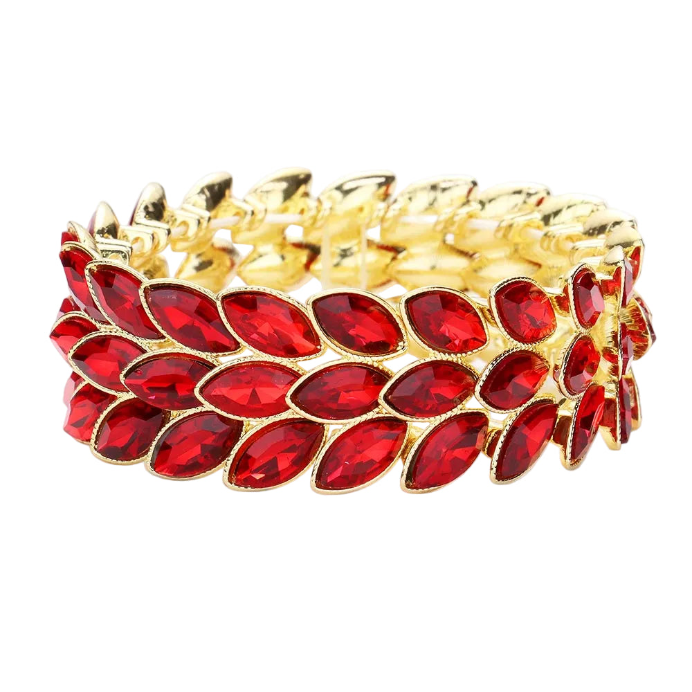 Gold bracelet with red gemstones on a white background