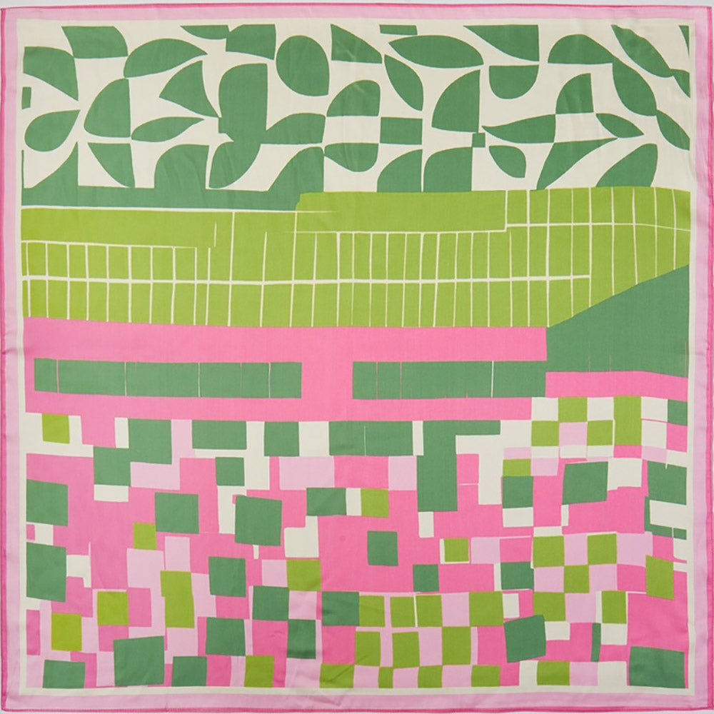 Colorful quilt with geometric pattern in pink, green, and white.