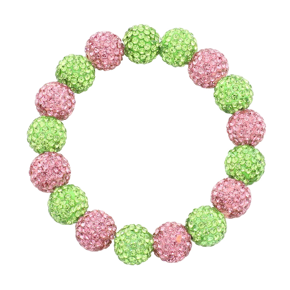 Bracelet with pink and green glittery beads on a white background