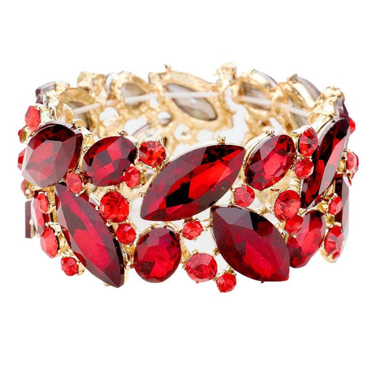 Gold bracelet with red gemstones on a white background