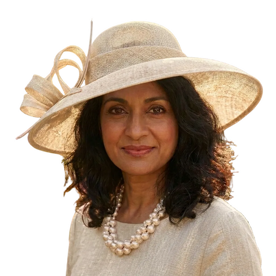 Woman wearing a wide-brimmed hat with decorative elements in an outdoor setting.