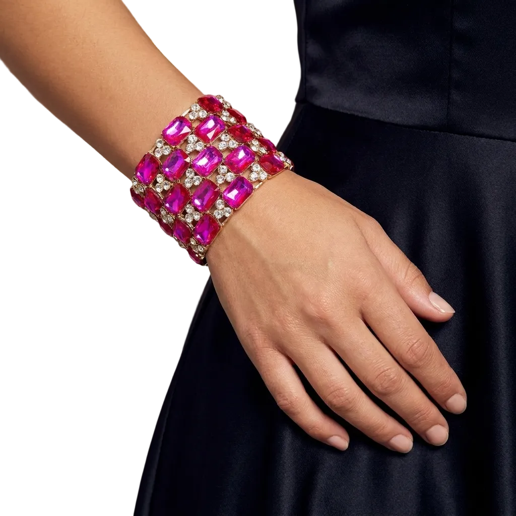 Hand wearing a pink gemstone bracelet with a blurred background