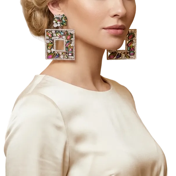 Woman wearing large, decorative earrings in an elegant room.