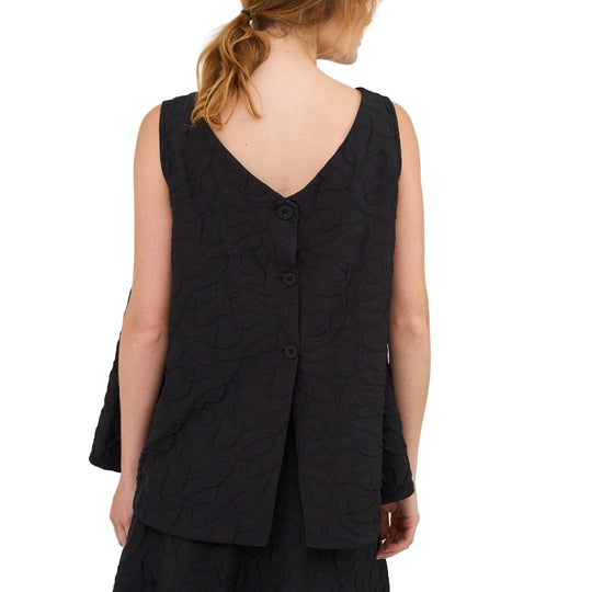 Woman wearing a black sleeveless top and skirt set on a white background