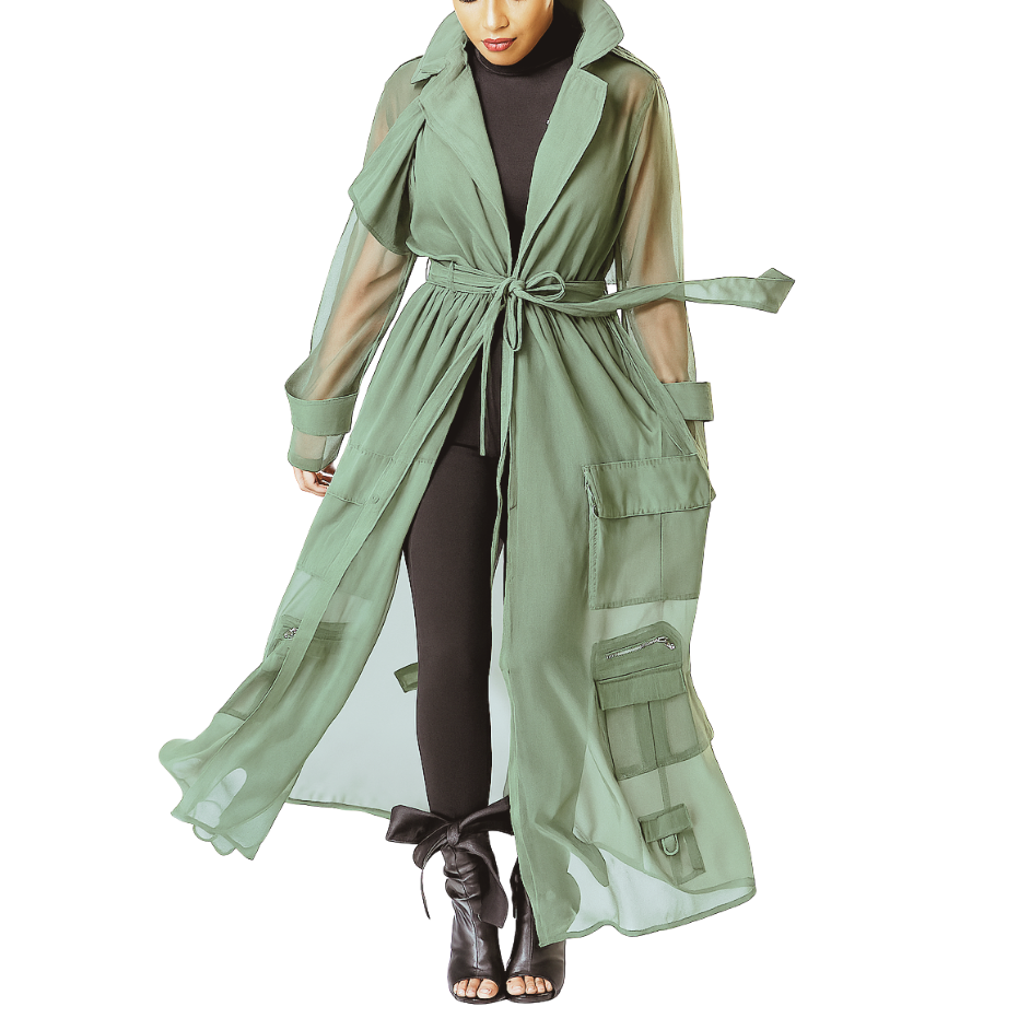 Woman wearing a long green trench coat on a white background