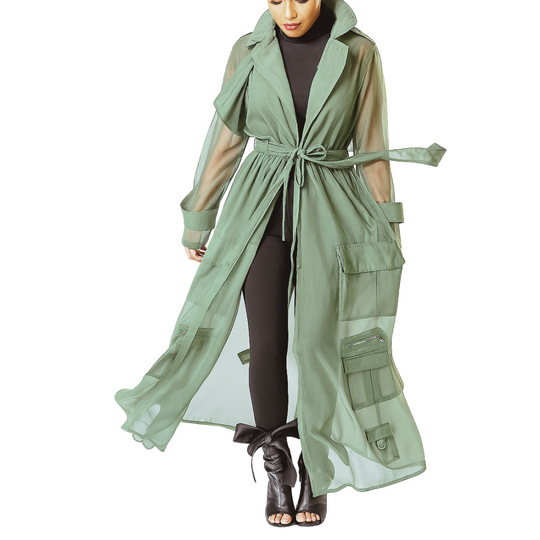 Green trench coat with sheer panels worn by a model on a white background