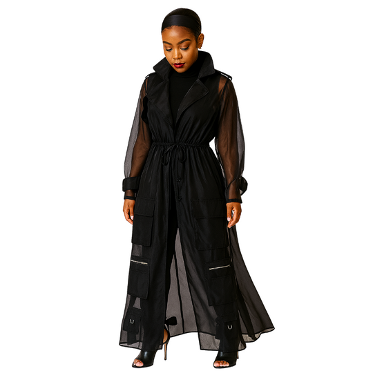 Woman wearing a long black dress with sheer sleeves on a white background