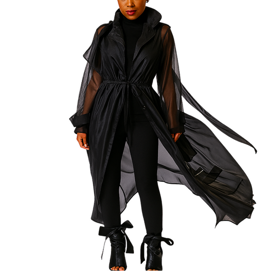 Woman wearing a black outfit with sheer sleeves on a white background