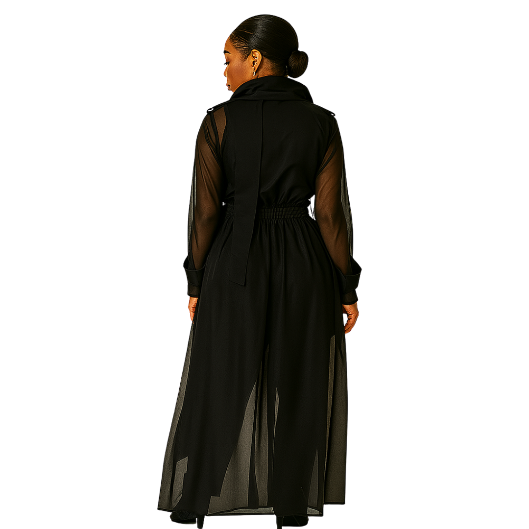 Woman wearing a long black dress with sheer sleeves on a white background