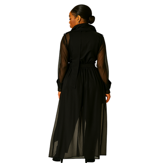 Woman wearing a long black dress with sheer sleeves on a white background