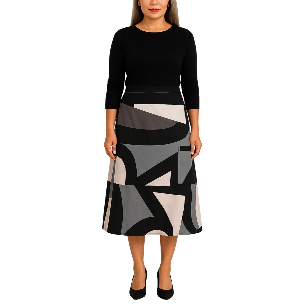 Woman wearing a black top and patterned skirt on a white background