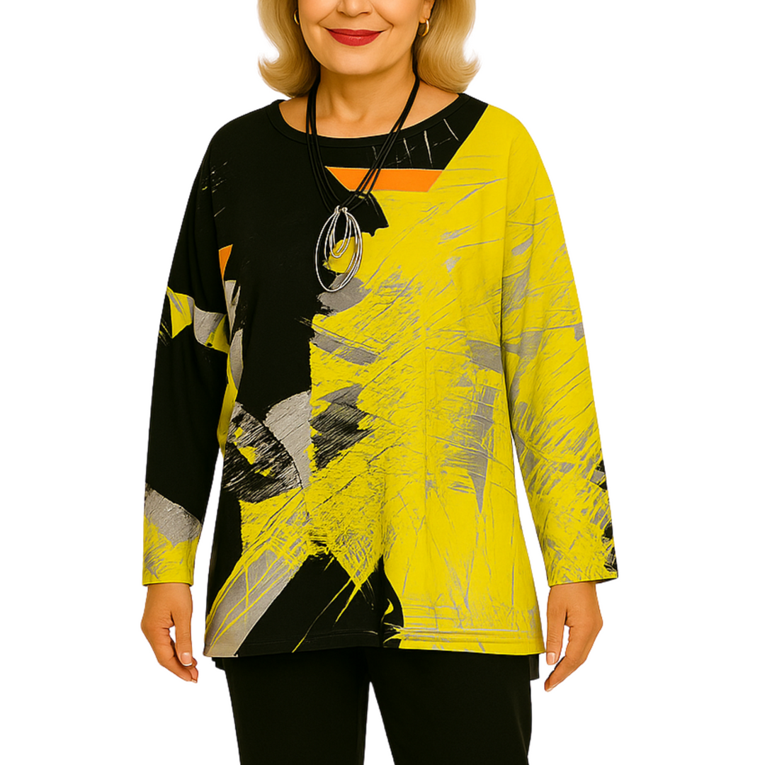 Woman wearing a yellow and black abstract patterned top on a white background