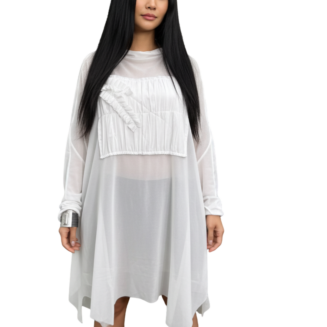 Woman wearing a white long-sleeve top and light gray skirt on a white background