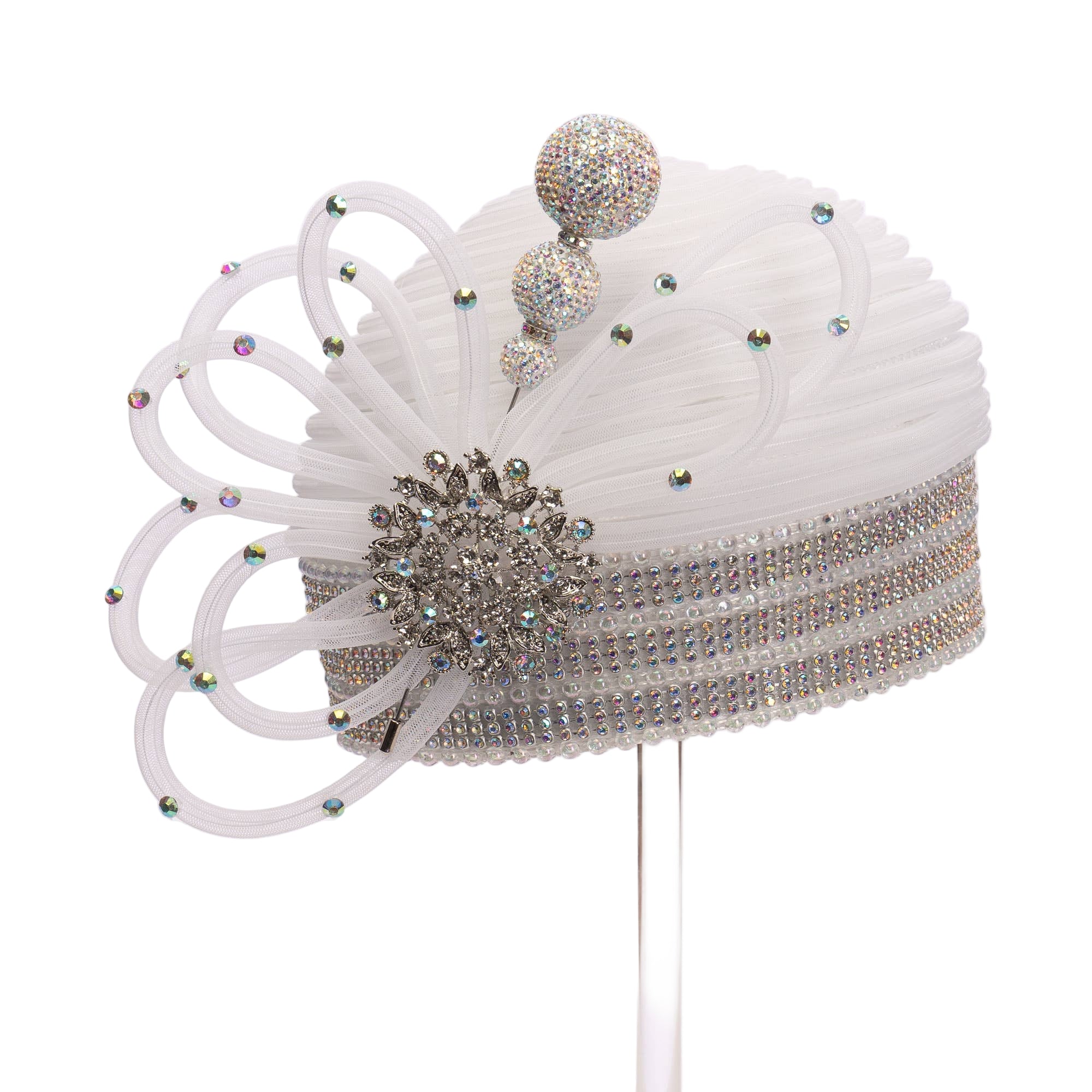 A white round rhinestone-covered hat with a floral-like pattern and a crystal ball hat pin.