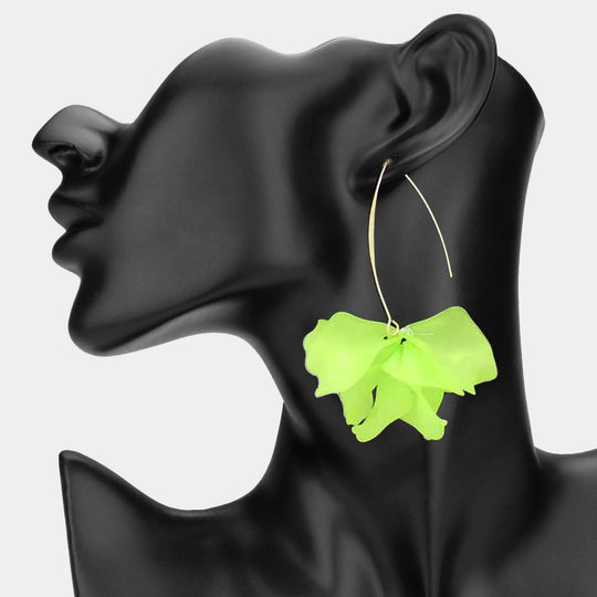 Neon green butterfly-shaped earring on a black mannequin ear