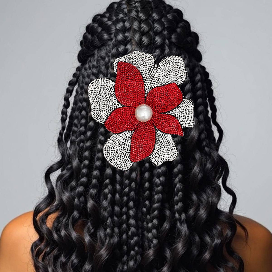 Delta Sigma Theta rhinestone flower brooch pin and hair clip with red petals, pearl center, and clear rhinestone accents on black felt backing.