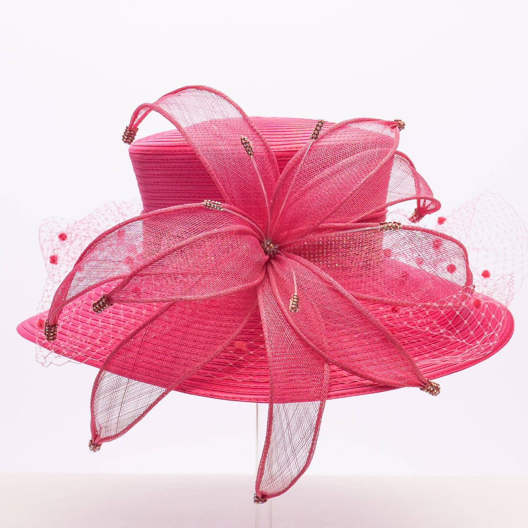 Pink decorative bow with mesh layers on a white background