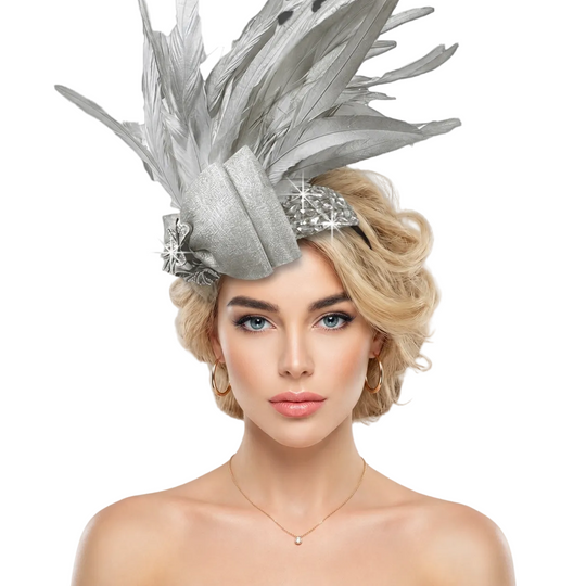 Woman wearing a silver feathered headpiece against a gray background