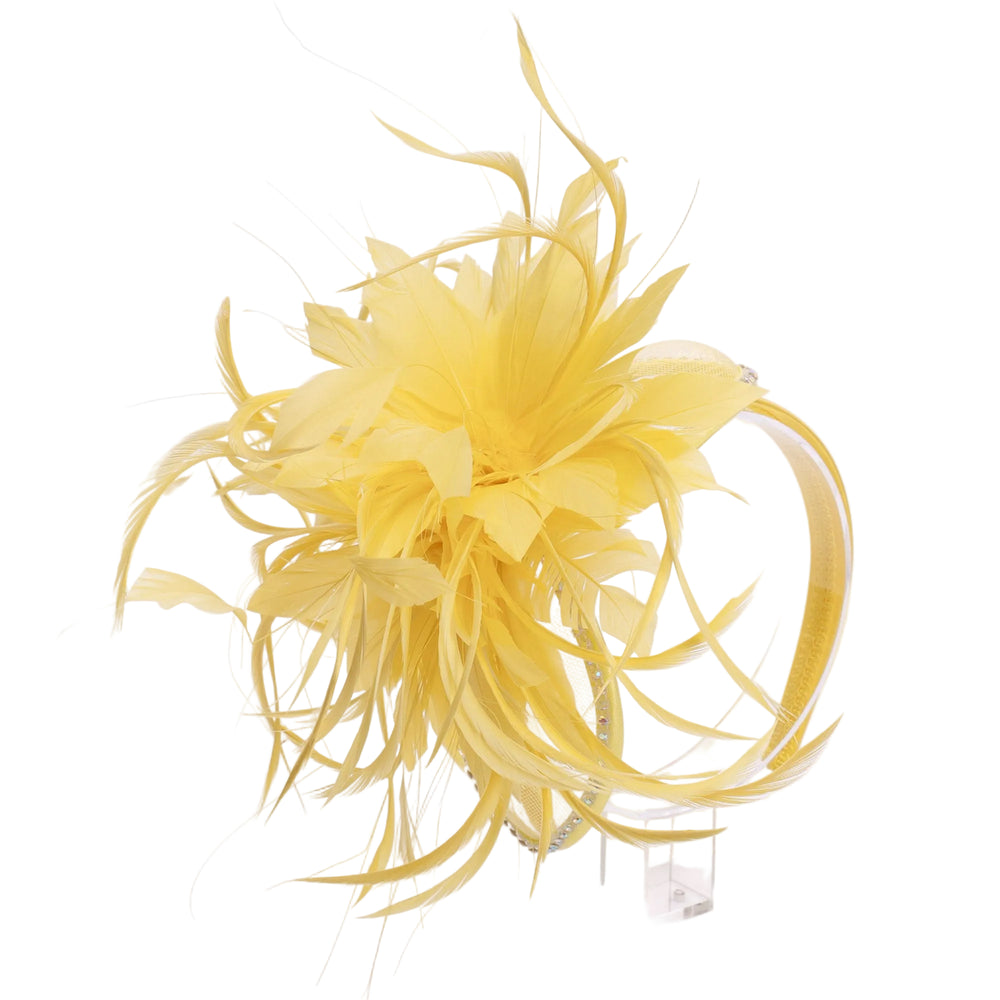 Yellow feathered headpiece on a clear stand against a white background
