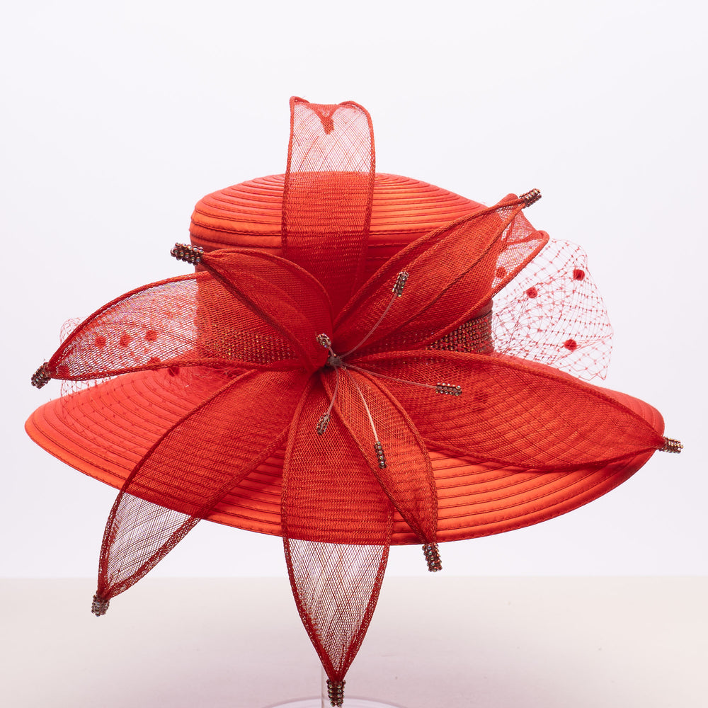 Red decorative hat with mesh details on a white background