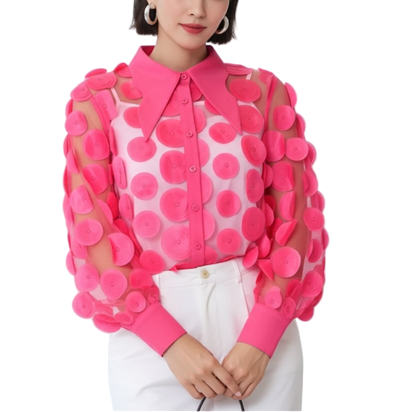 Woman wearing a pink blouse with floral patterns in an office setting