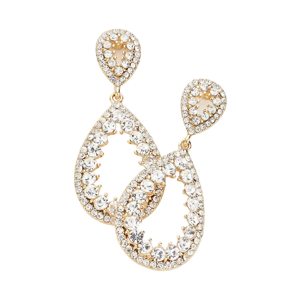 Gold and crystal earrings on a light gray background