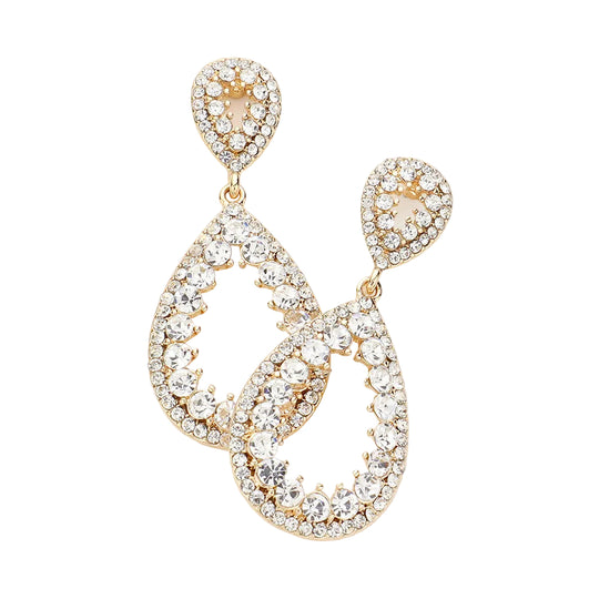 Gold and crystal earrings on a light gray background