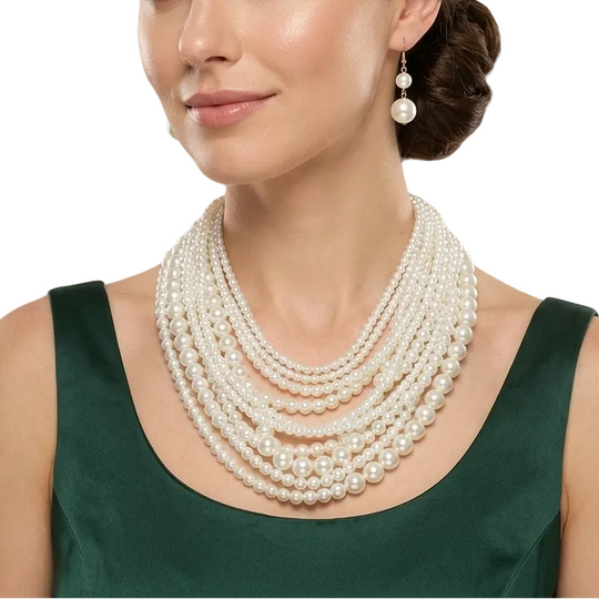 Woman wearing a pearl necklace and earrings in an elegant interior setting