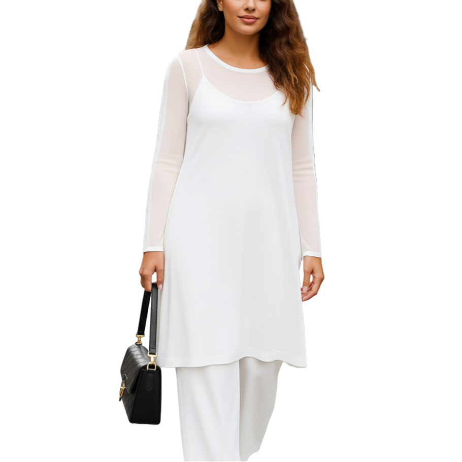 Woman in a white dress standing on a city street