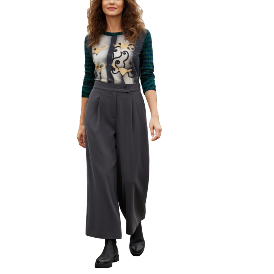 Woman standing in a greenhouse with plants and flowers around her