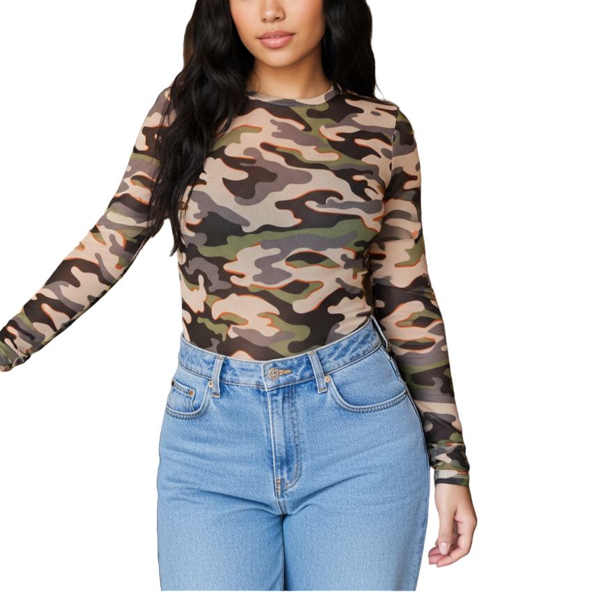 Woman wearing a camouflage long-sleeve top and blue jeans in a coffee shop.