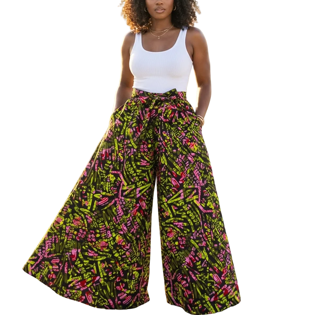 Woman wearing colorful patterned pants and a white top on a rooftop with cityscape background
