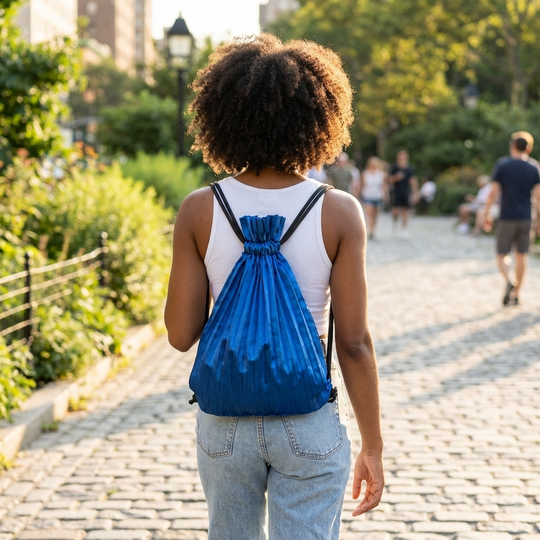 woman wearing a blue pleated satin backpack