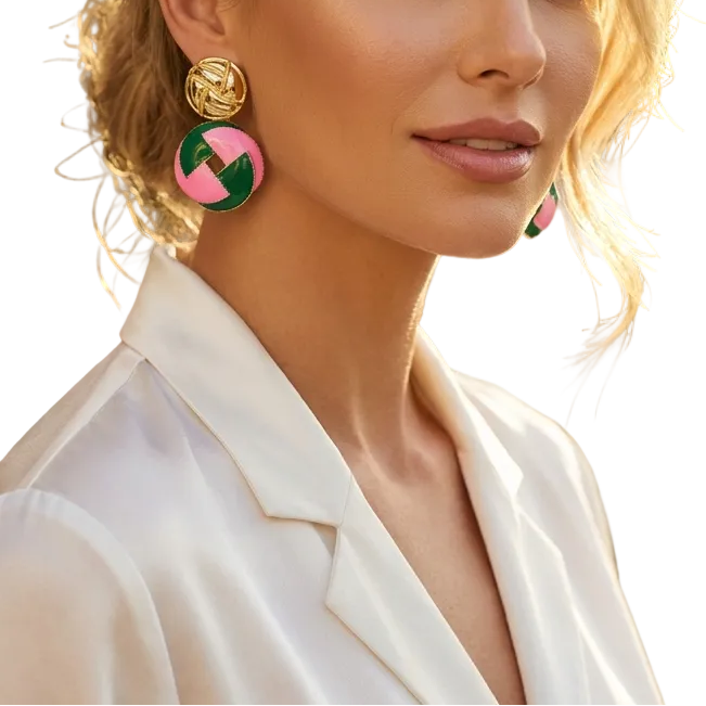 Woman wearing colorful earrings with a blurred outdoor background