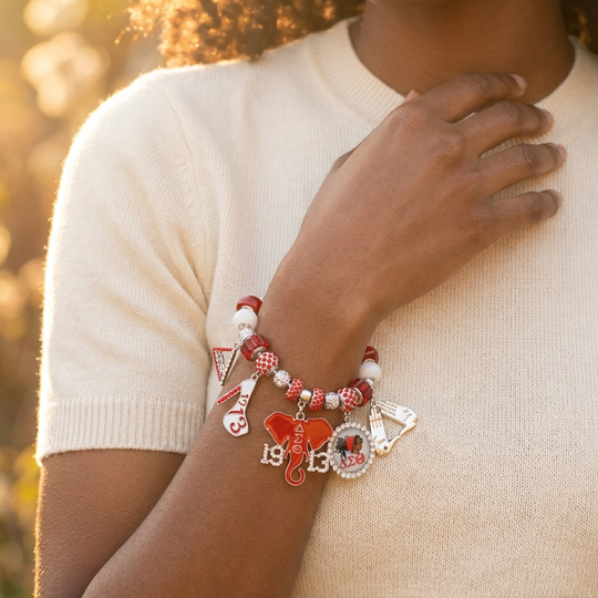 Delta Sigma Theta silver-tone adjustable charm bracelet with enamel DST symbols and red and white crystal beads.