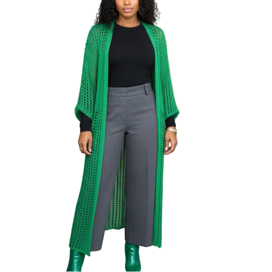 Woman wearing a green cardigan, black top, and gray pants in an office setting