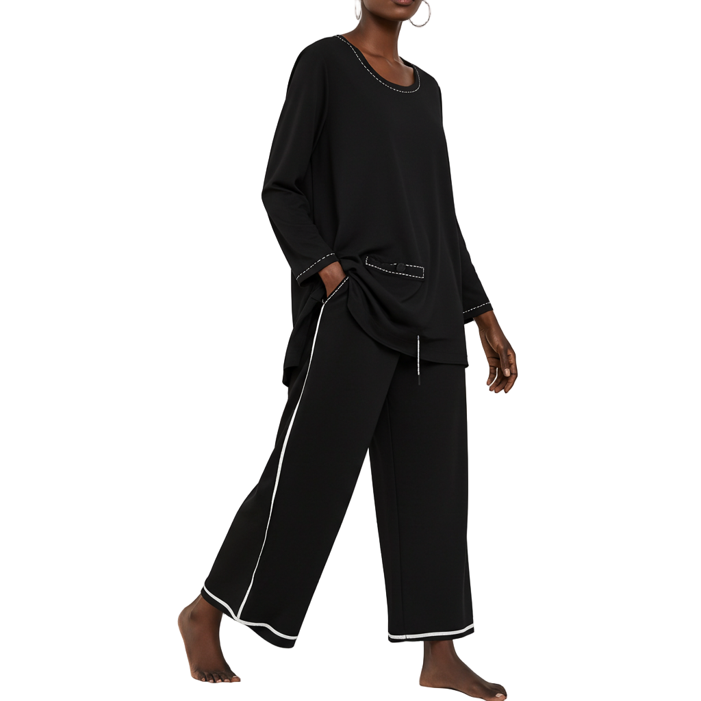 Black outfit with white trim worn by a model on a white background