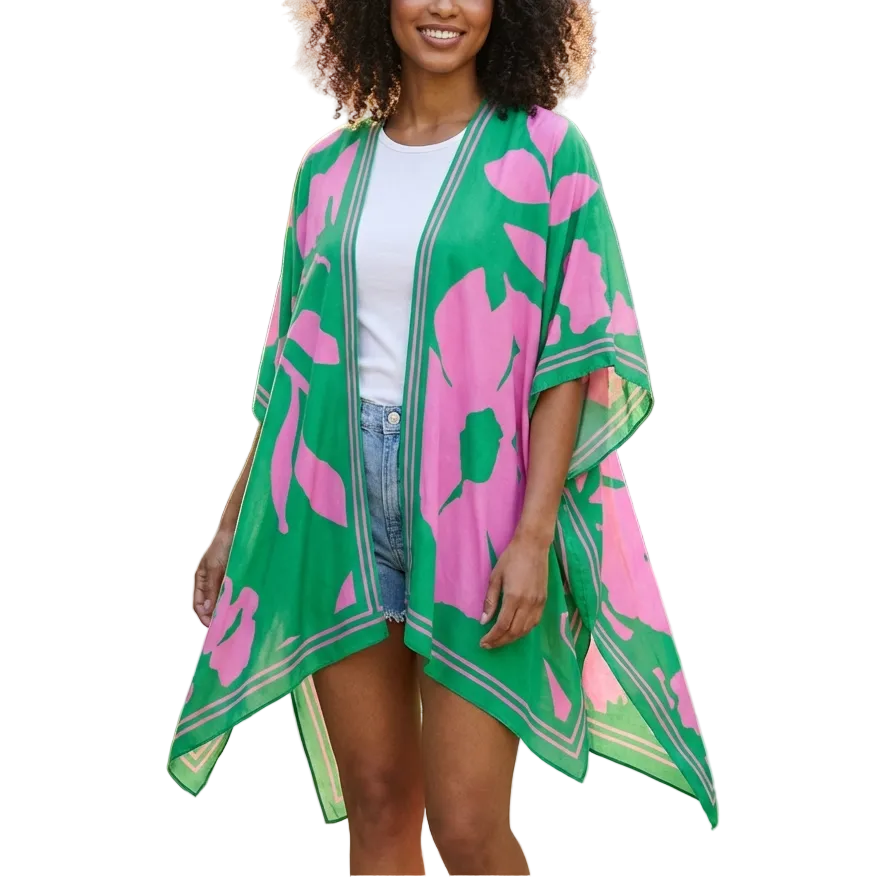 Woman wearing a green and pink floral kimono in a garden setting