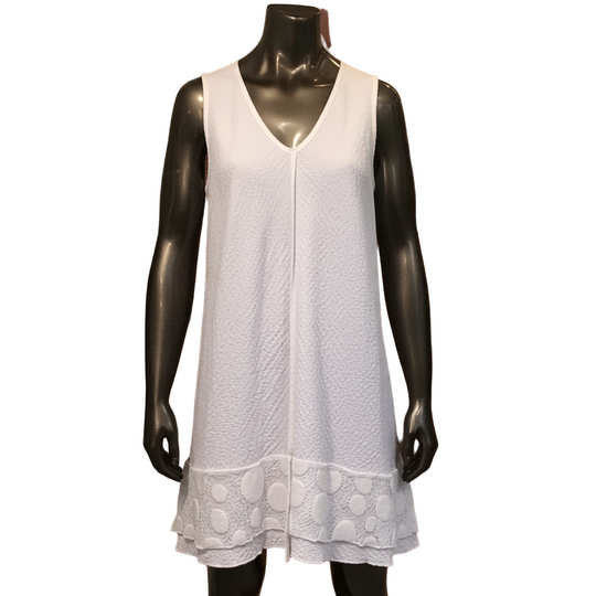 White sleeveless dress on a mannequin in a clothing store setting