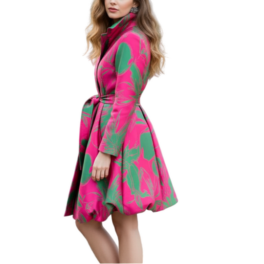 Woman wearing a pink and green coat in a park setting