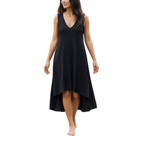 Woman in a black dress walking in a garden setting